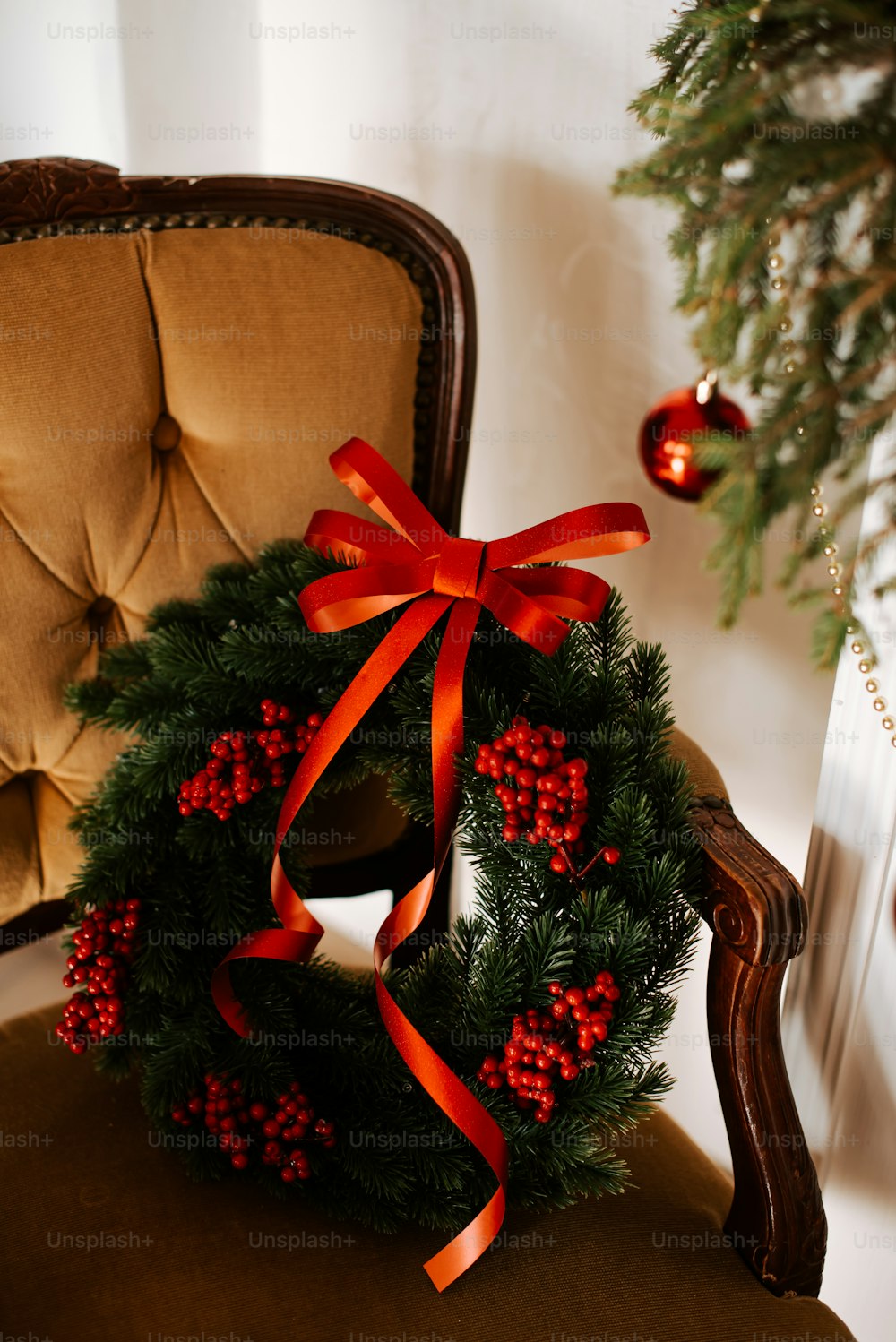 a christmas wreath sitting on top of a chair
