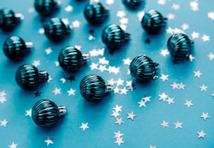 a bunch of black and white balls and stars on a blue background