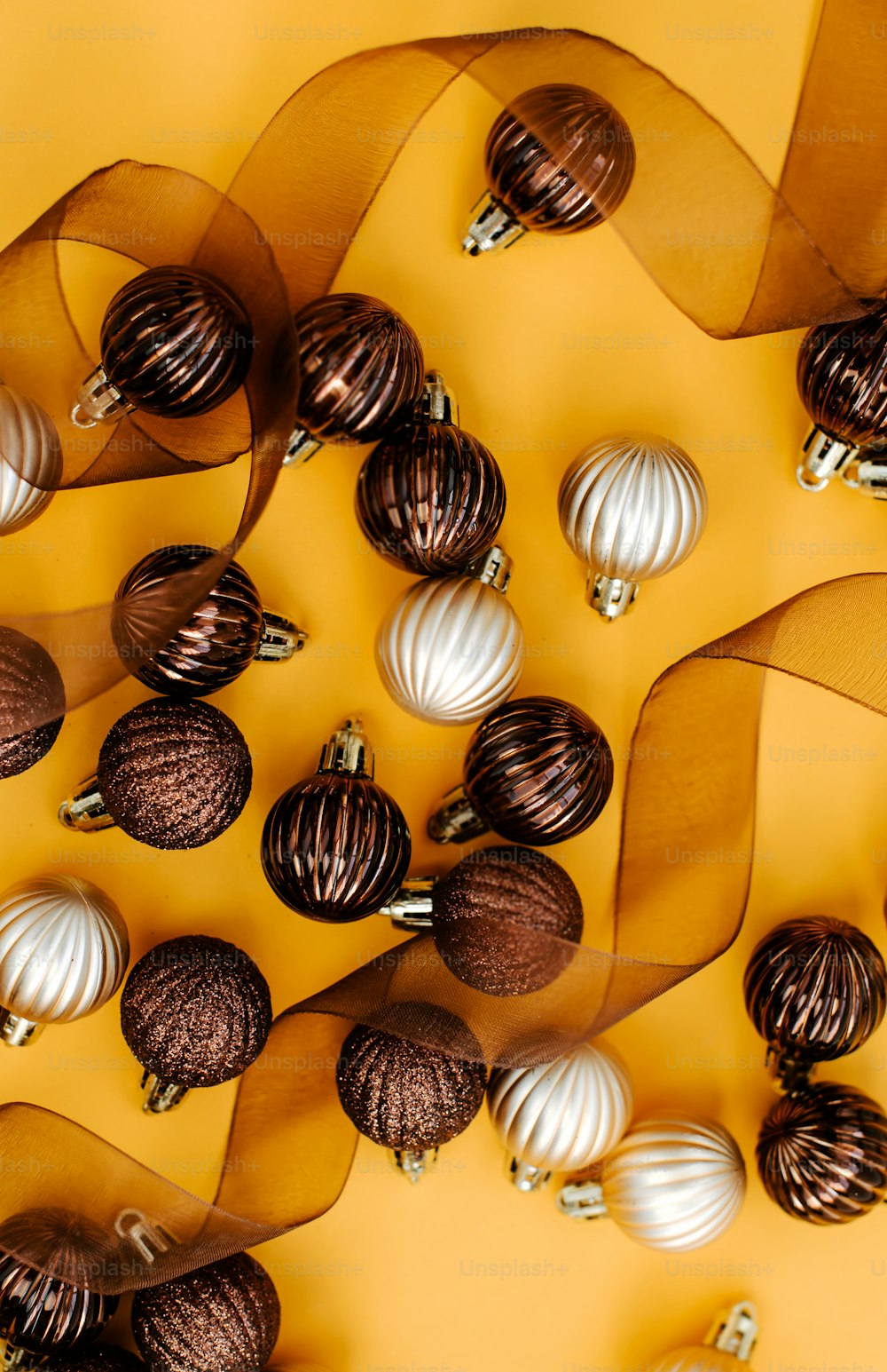 a bunch of christmas ornaments on a yellow background
