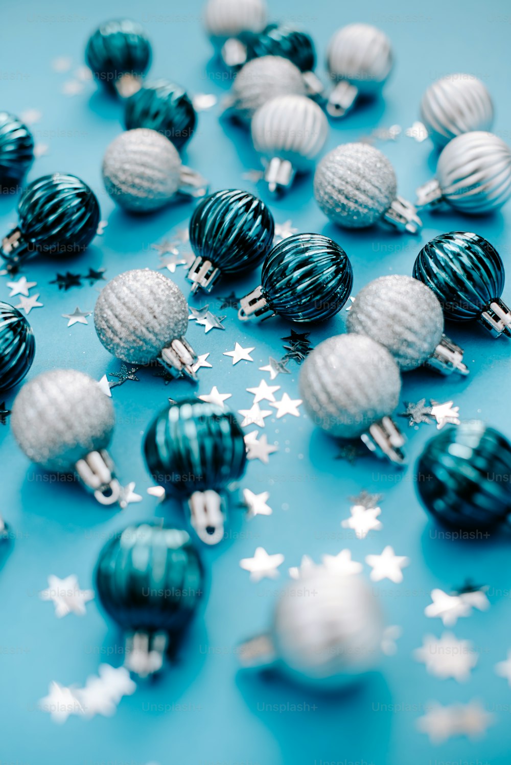 a bunch of christmas ornaments on a blue surface