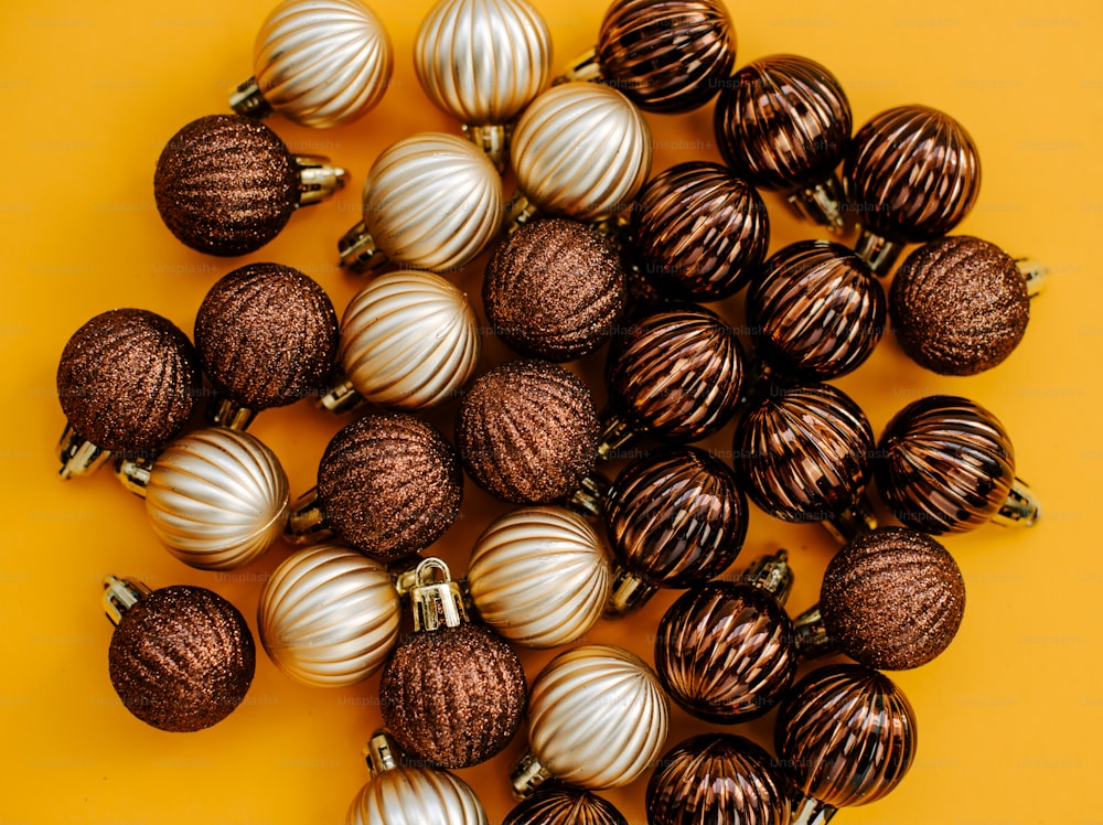 a pile of chocolate covered christmas ornaments on a yellow background