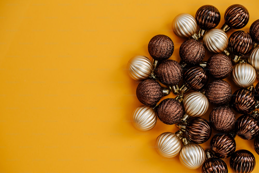 a bunch of chocolate balls sitting on top of a yellow surface