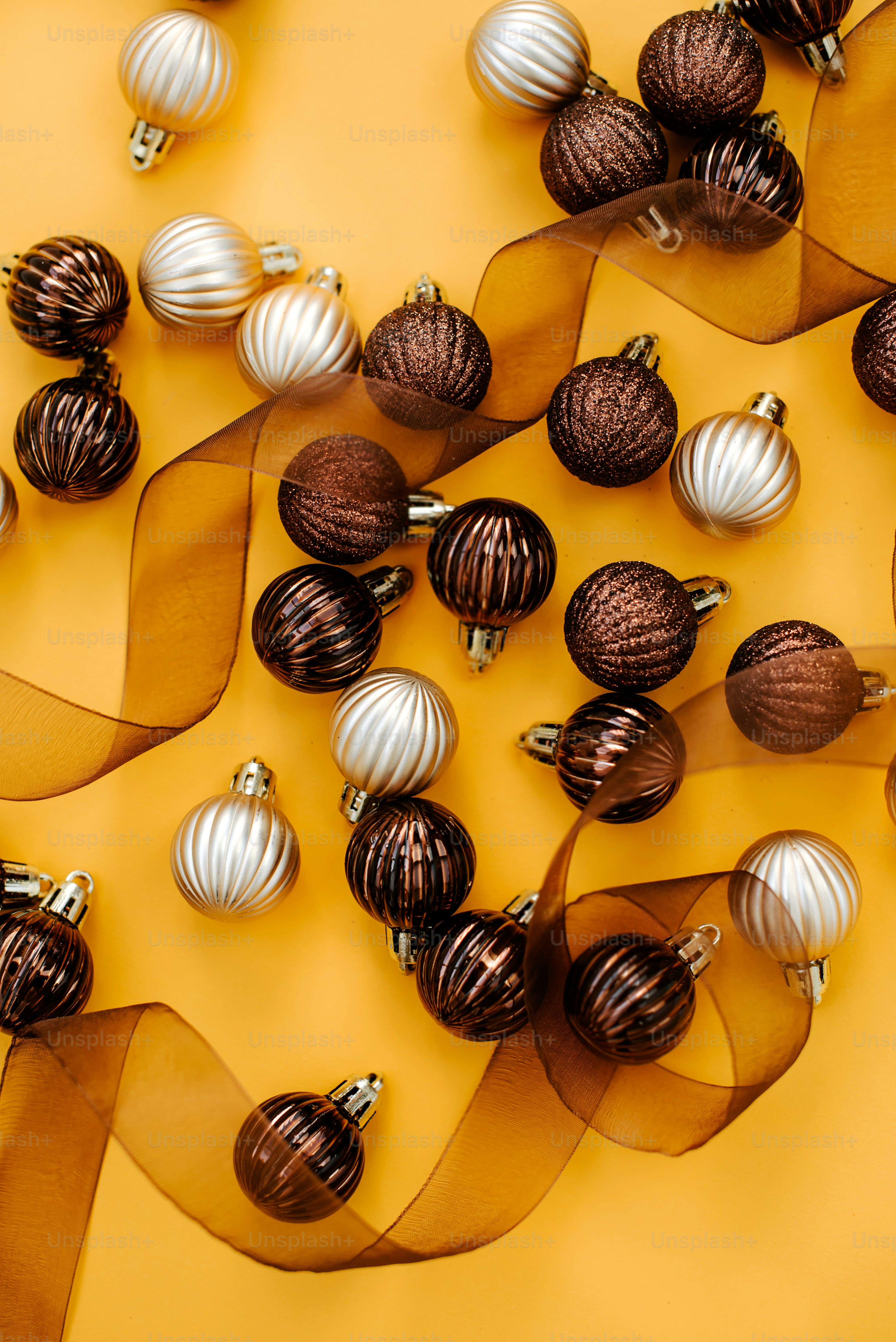 a bunch of christmas ornaments on a yellow background