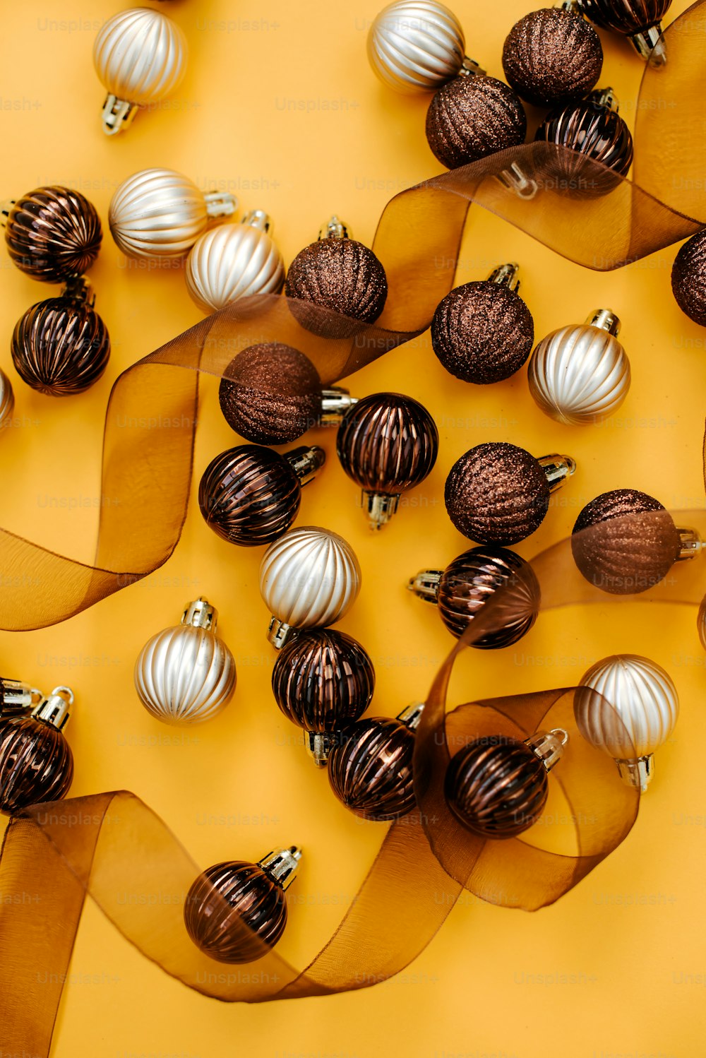 a bunch of christmas ornaments on a yellow background