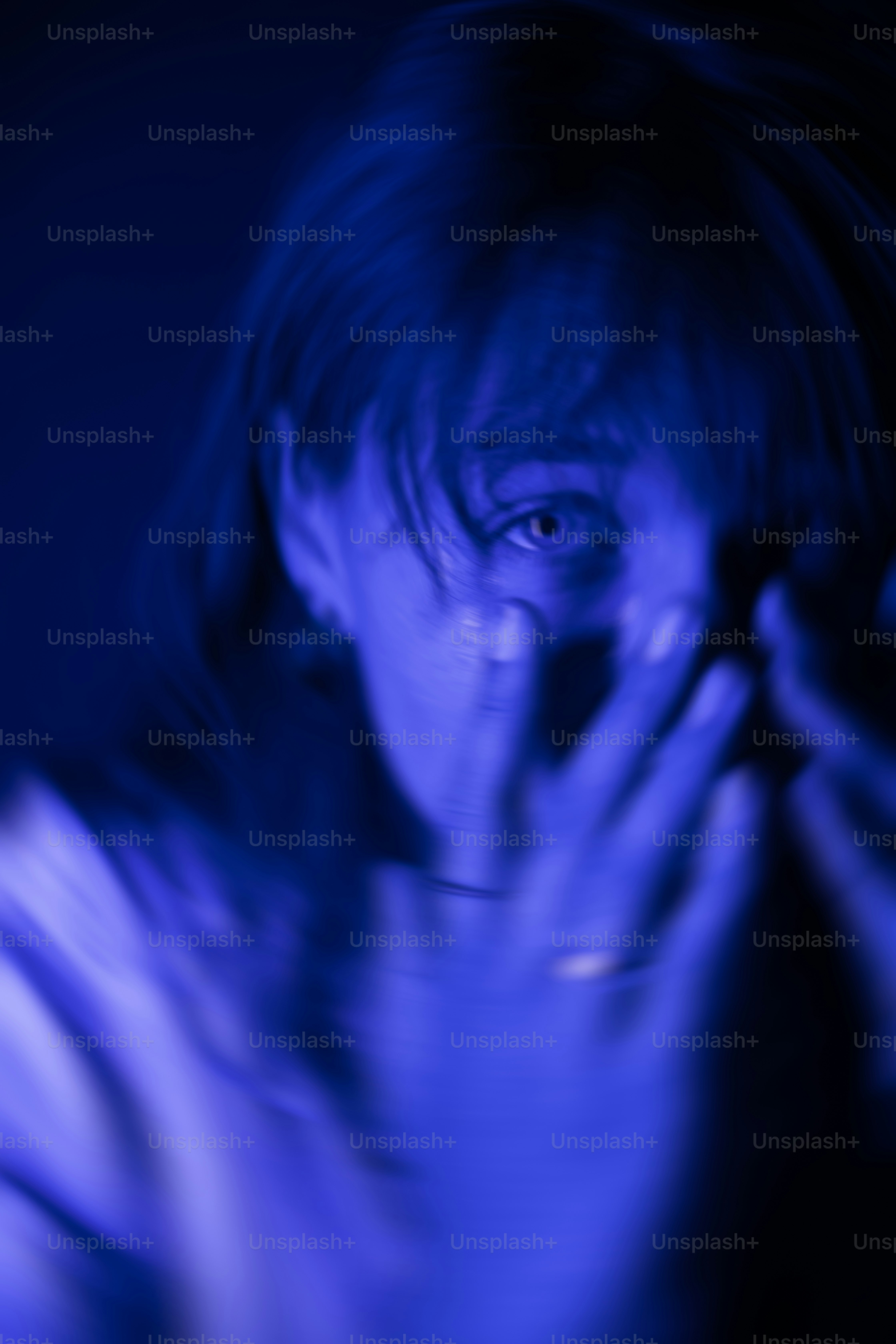 a man holding his hands up to his face