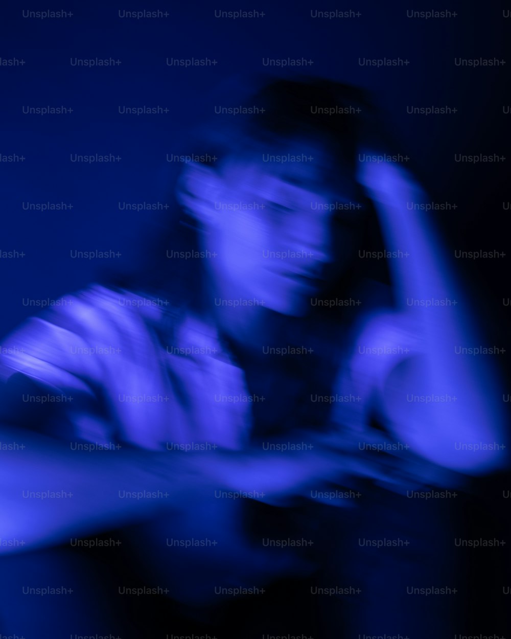 a blurry photo of a person holding a cell phone