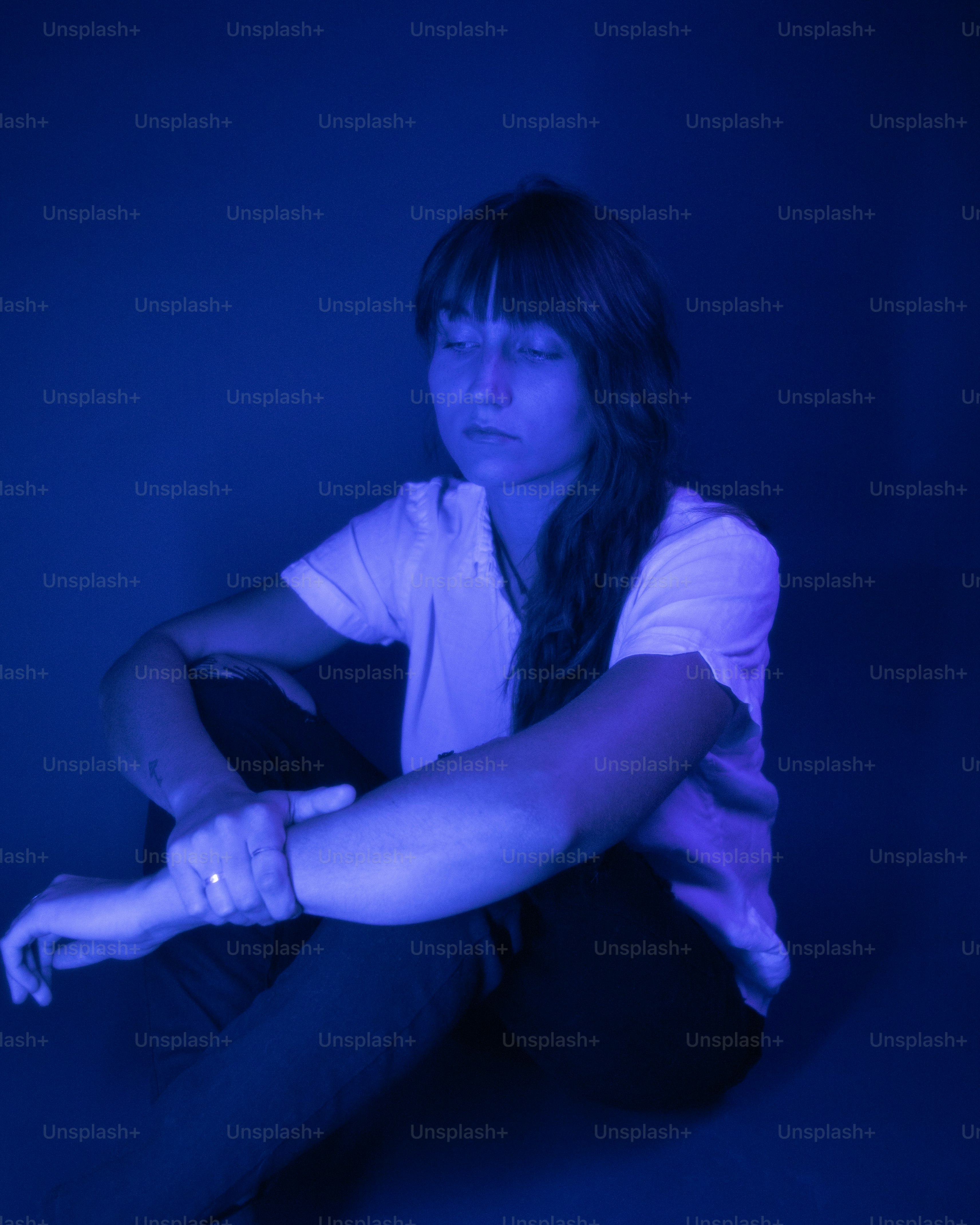 a woman sitting on the floor holding a wii controller