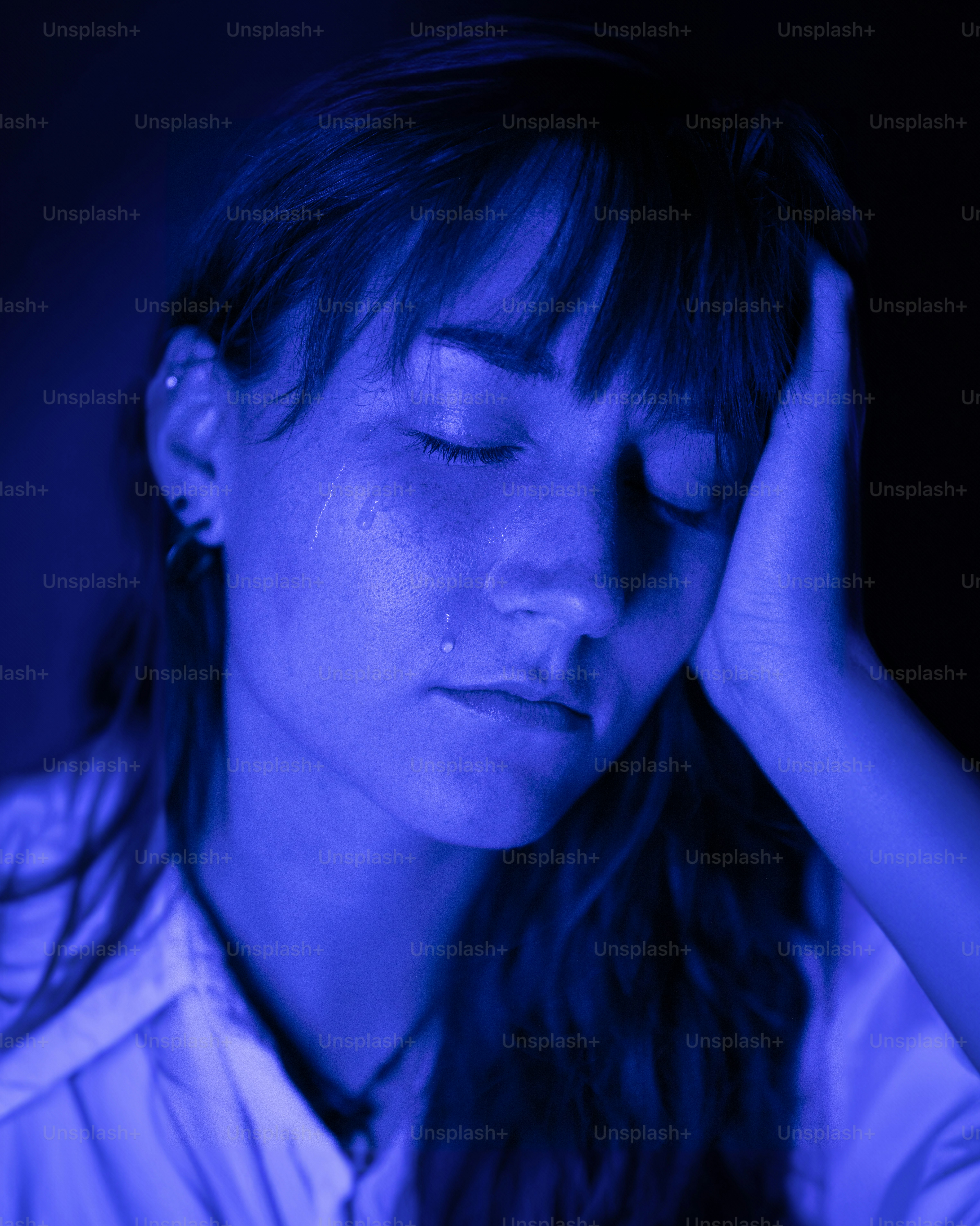 a woman holding her head in her hands