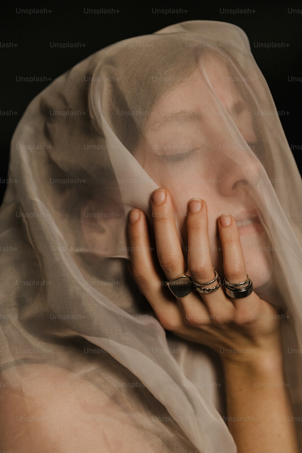 a woman wearing a veil covering her face