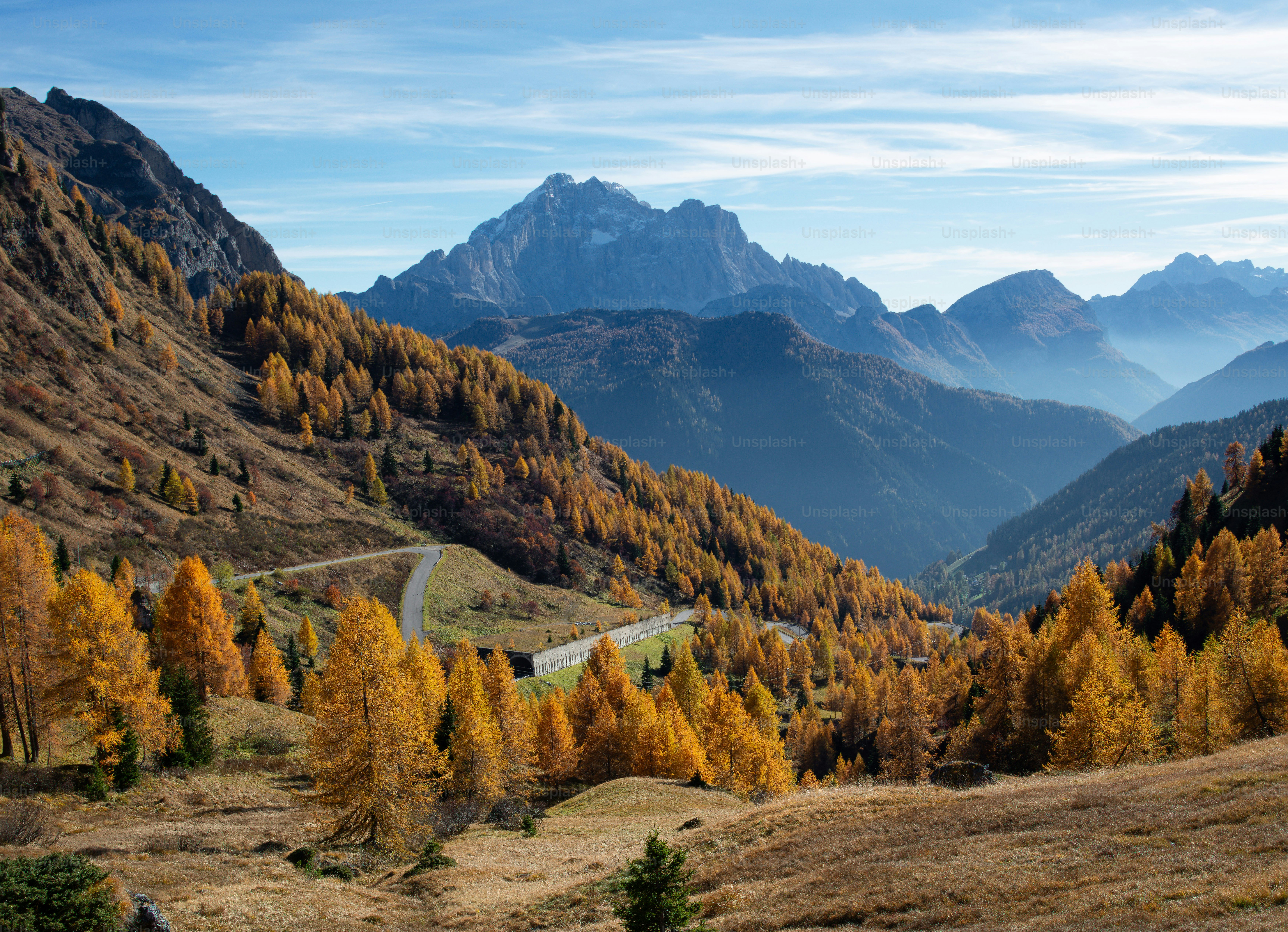 A scenic view of a road winding through the mountains photo – Autumn ...