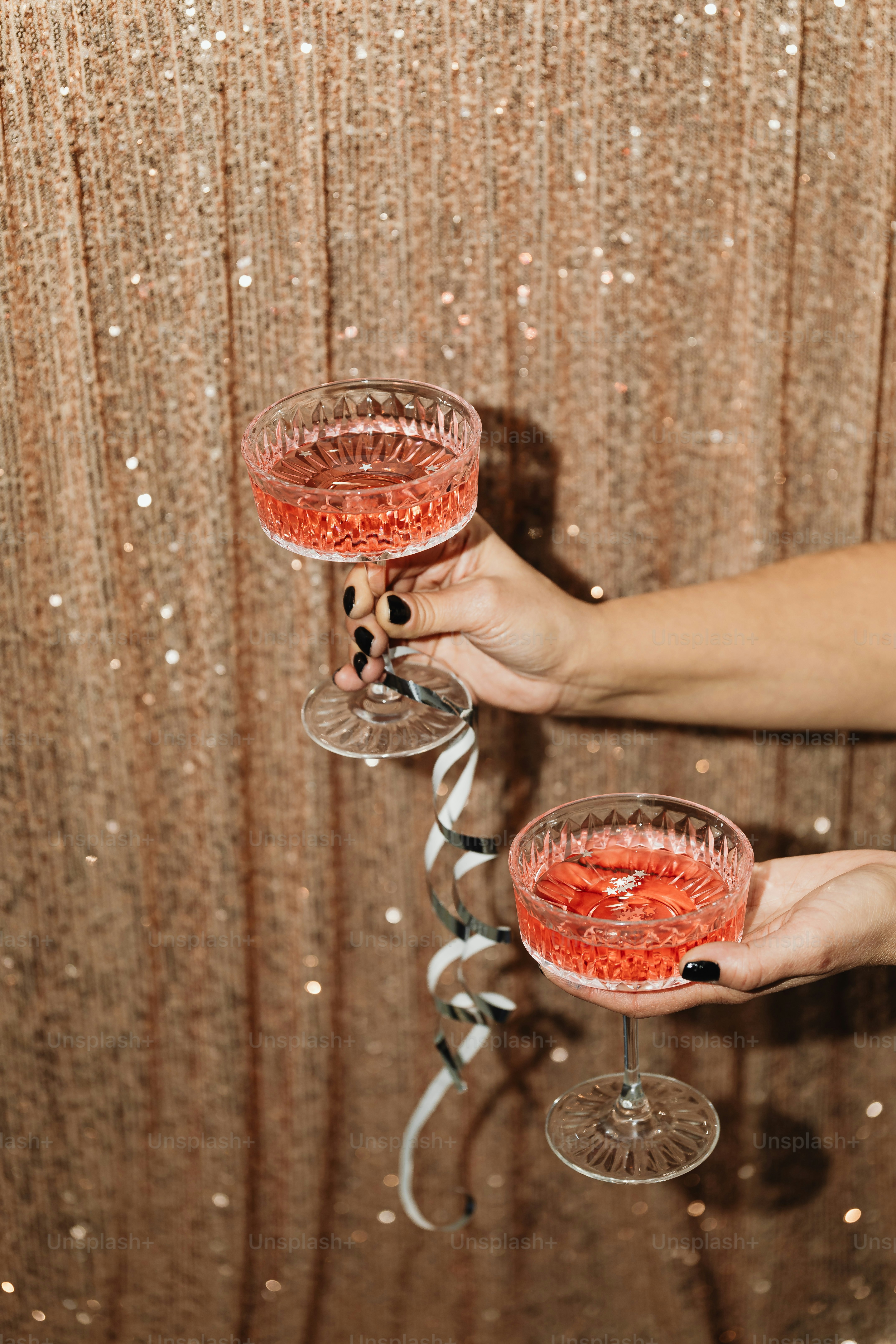 a couple of people holding up wine glasses