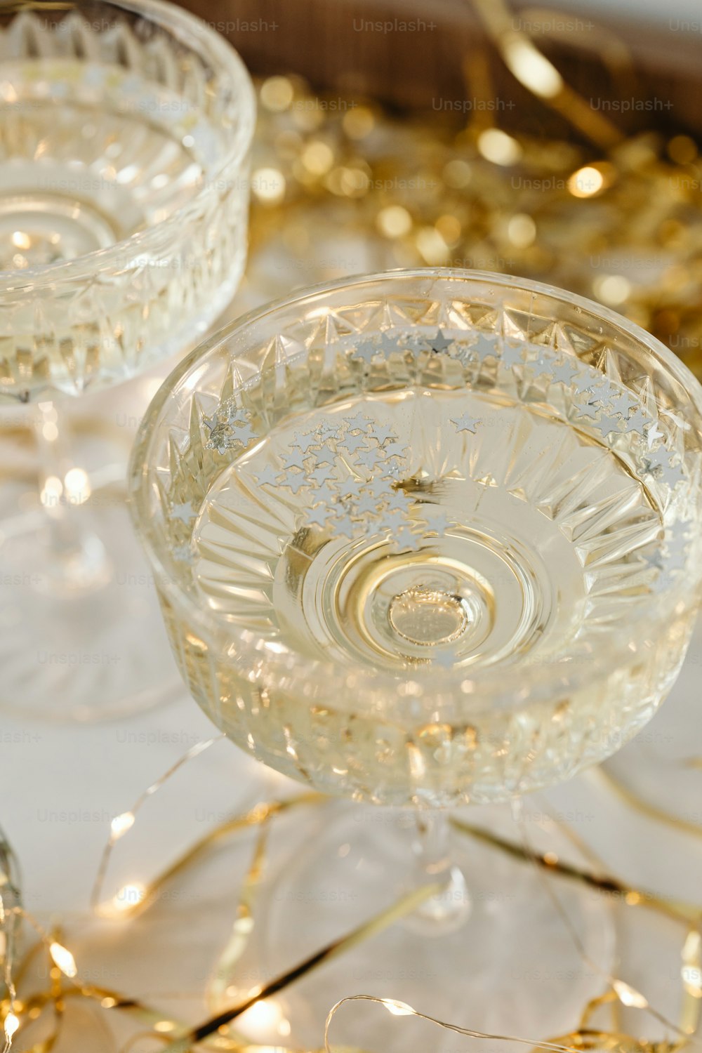 a close up of two wine glasses on a table