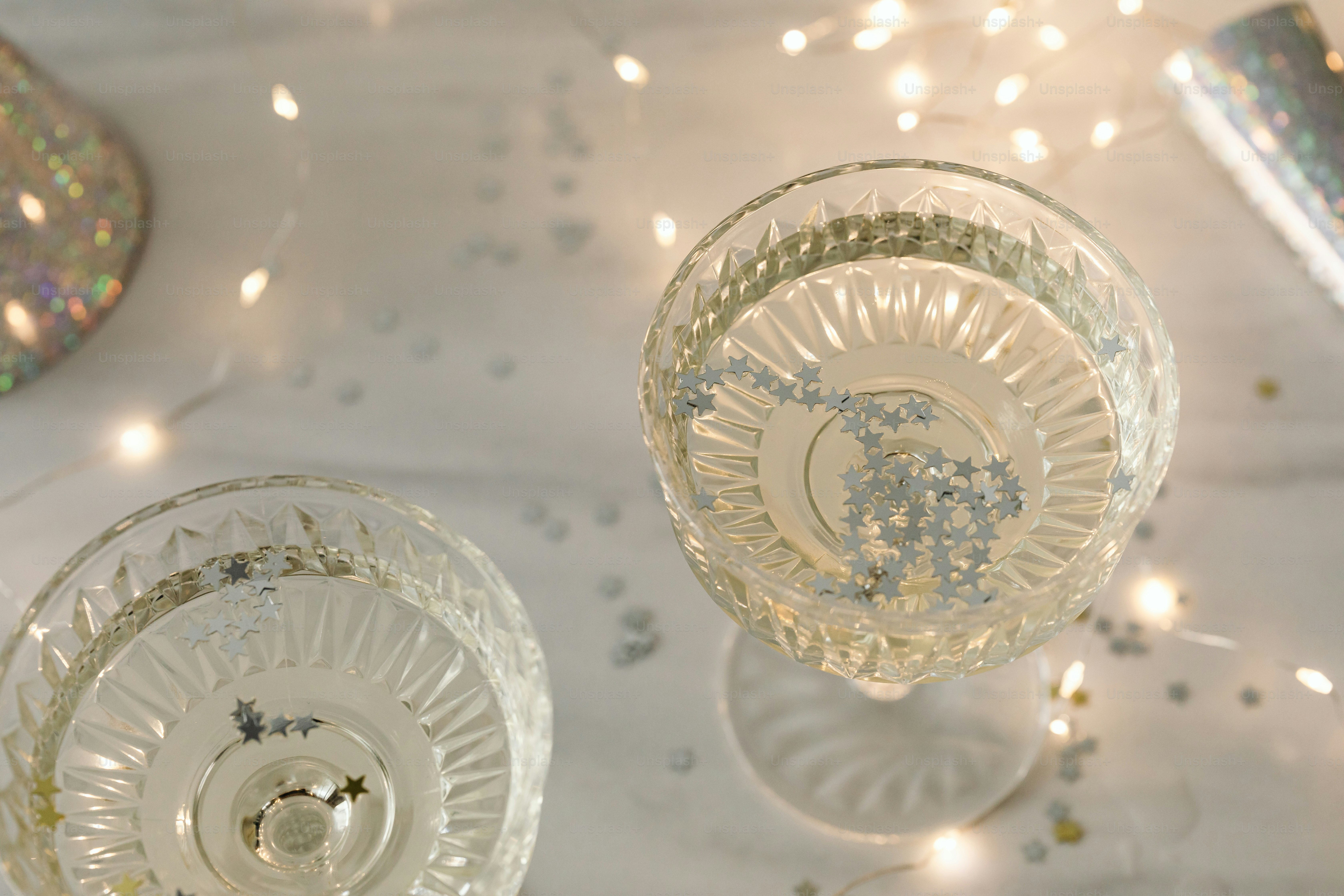 two clear wine glasses sitting on top of a table