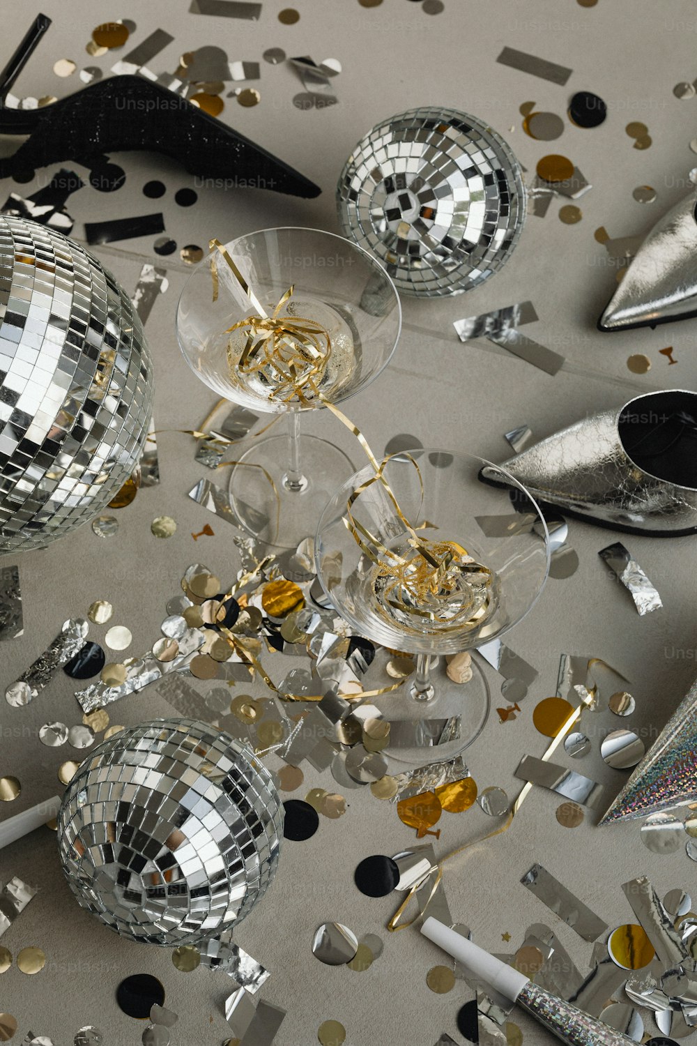 a table topped with disco balls and confetti