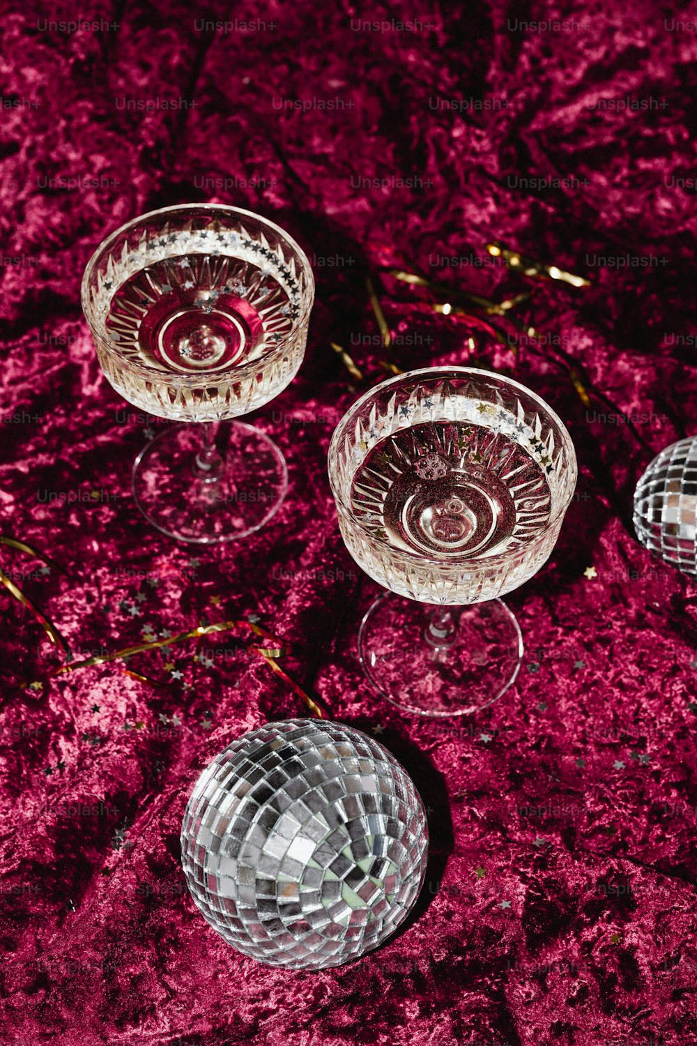 three wine glasses sitting on top of a table