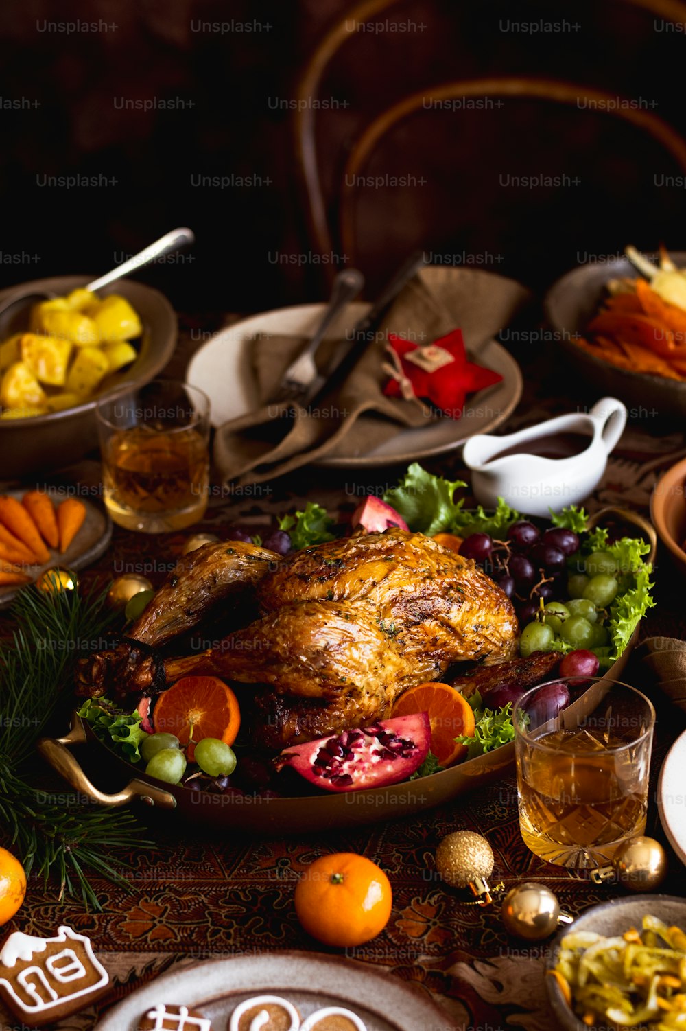 a table with a turkey, oranges, and other foods on it