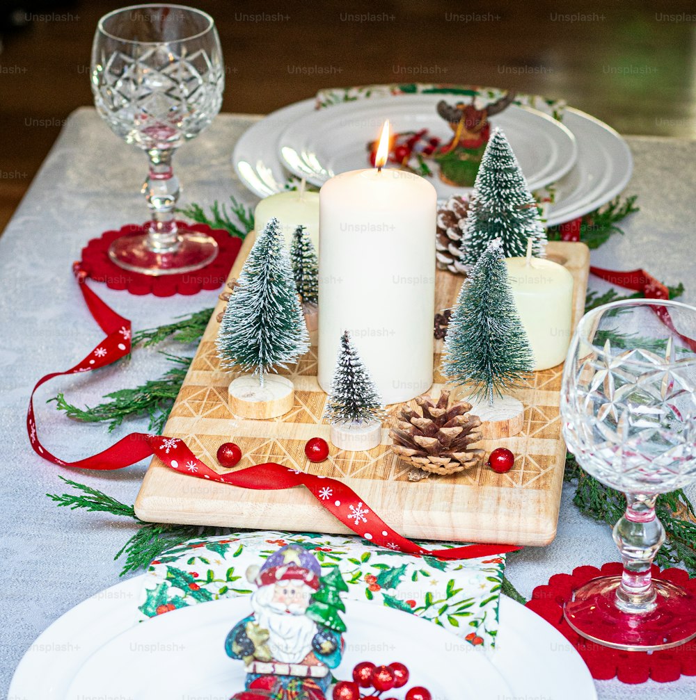 a christmas table setting with a candle and plates
