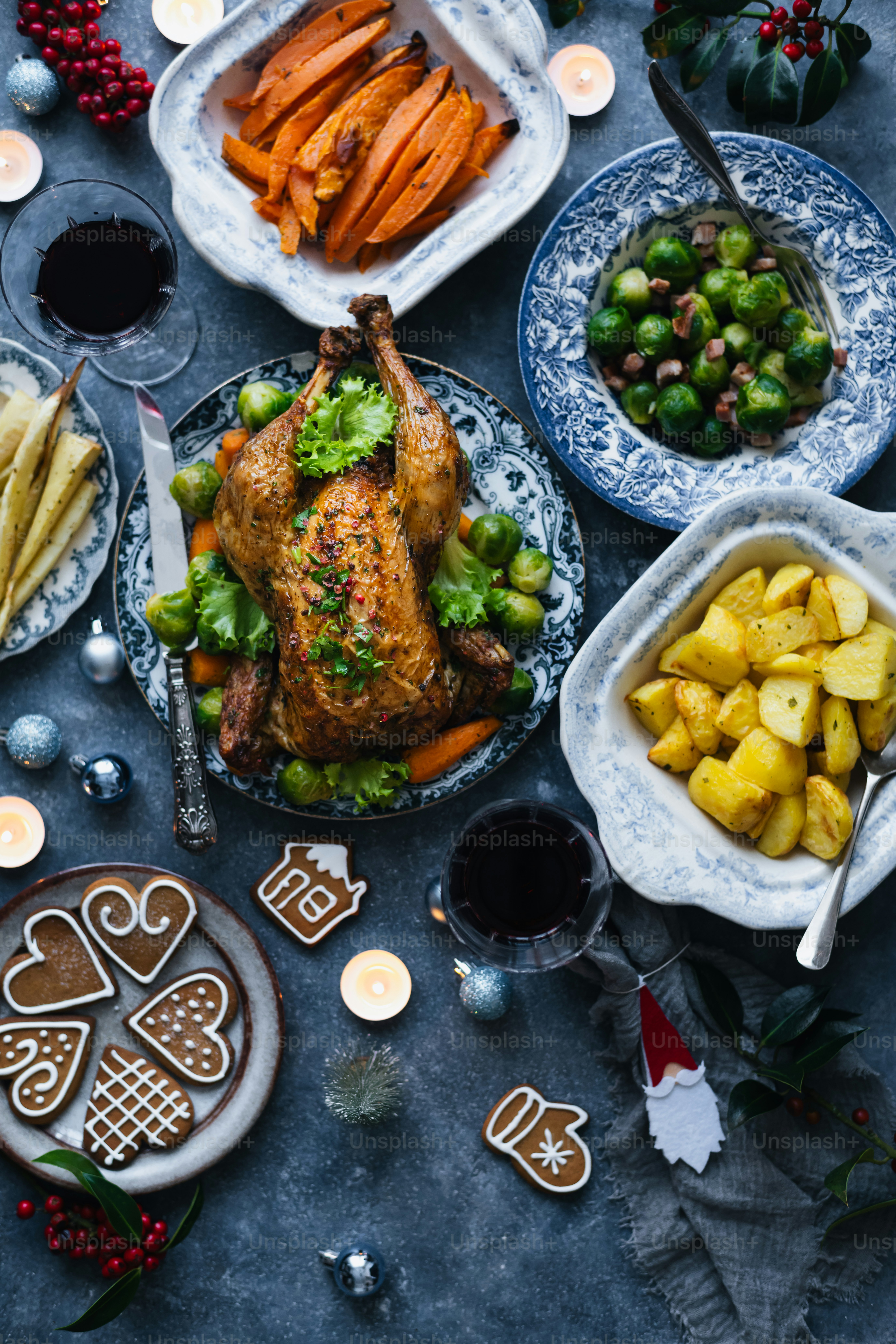a table topped with plates of food and candles