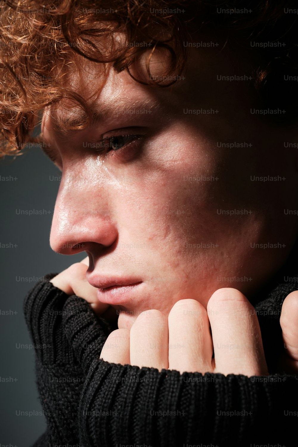 a close up of a person wearing a black sweater