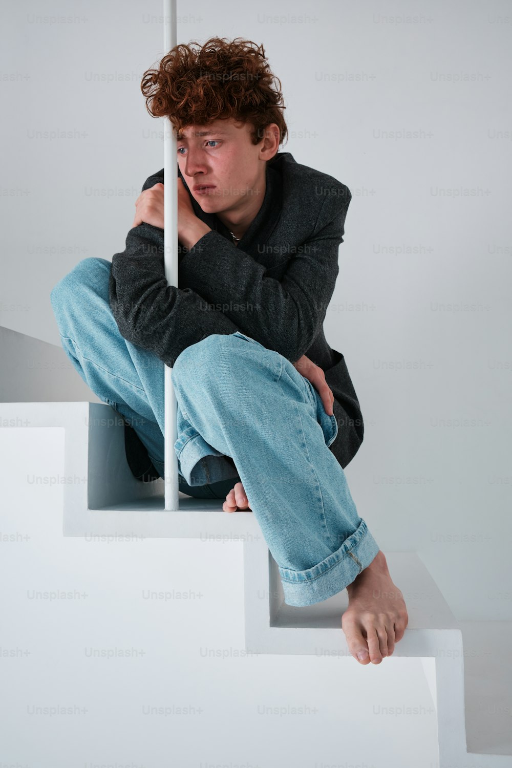 a man sitting on top of a set of stairs