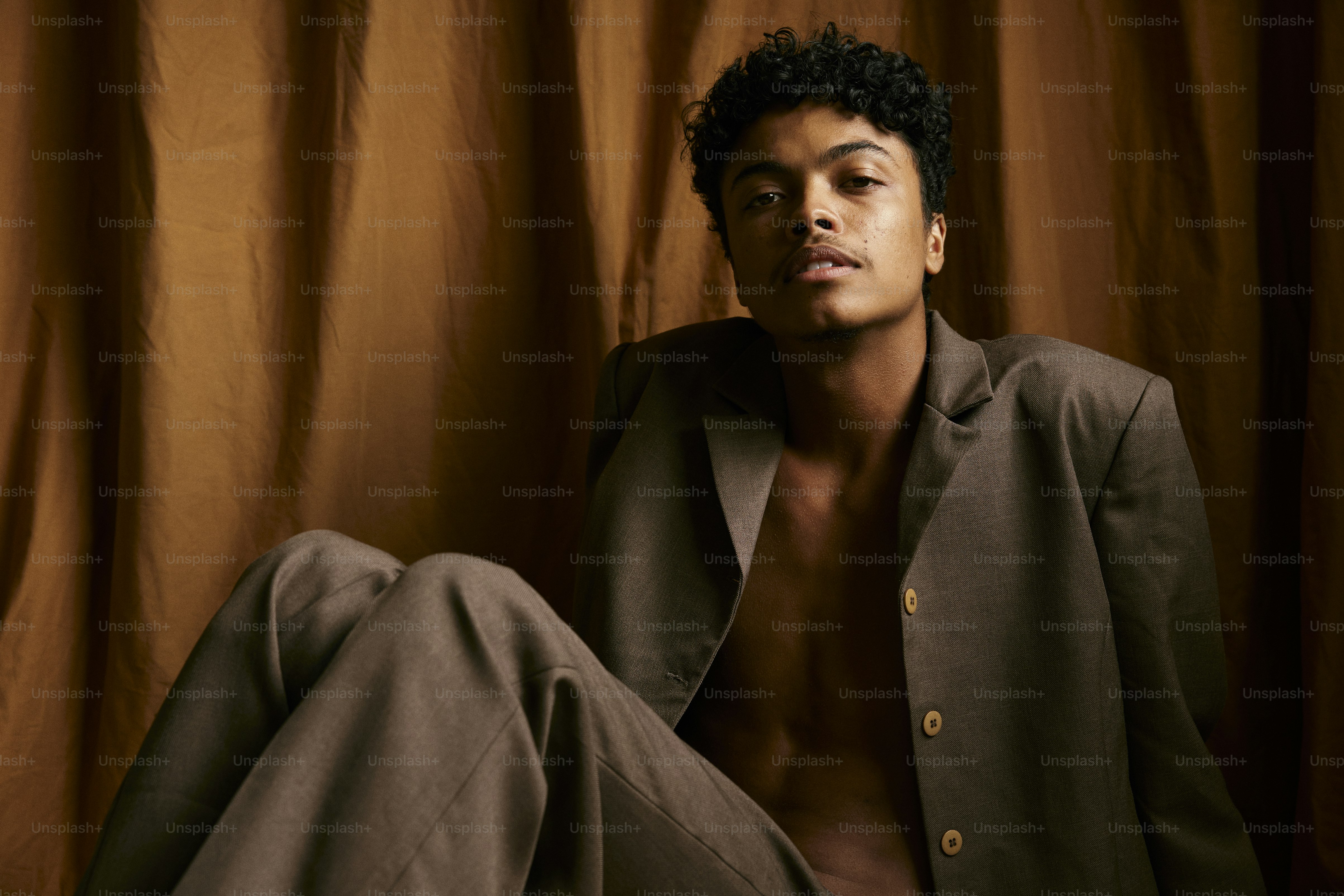 a man in a suit sitting on a chair