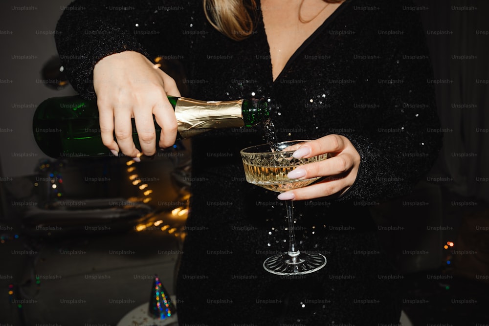 a woman pouring a drink into a glass