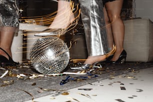 a disco ball being blown by a pair of legs