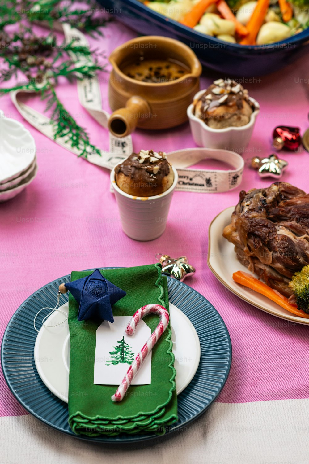 a table topped with plates of food and candy canes