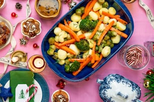 a platter of broccoli and carrots on a table