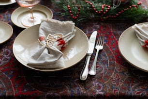 a table set for christmas with silverware and napkins