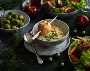 a table topped with bowls of soup and vegetables