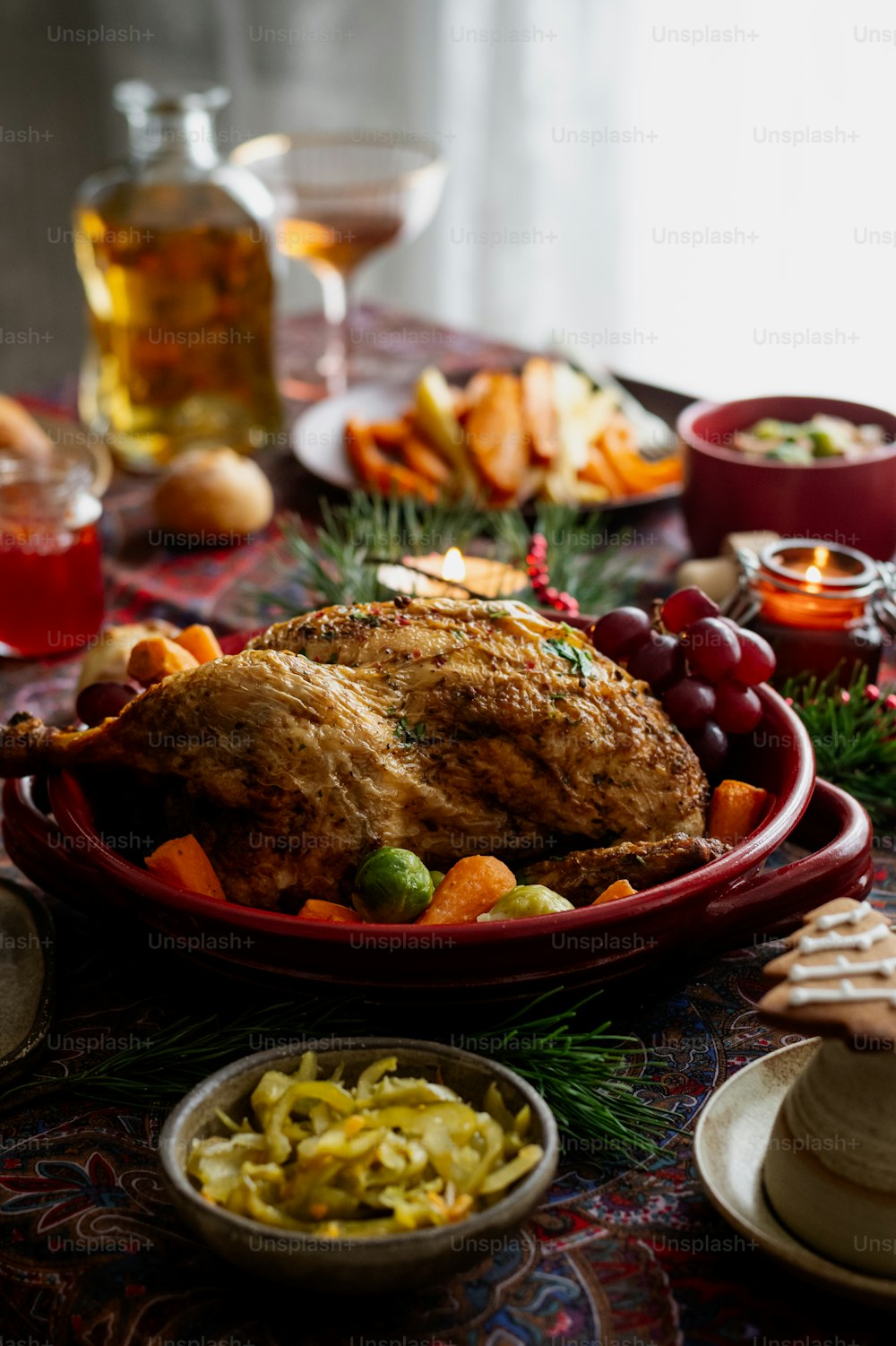 a table topped with a turkey and other foods