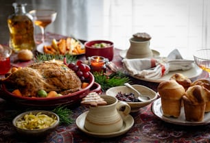 a table filled with dishes of food and drinks