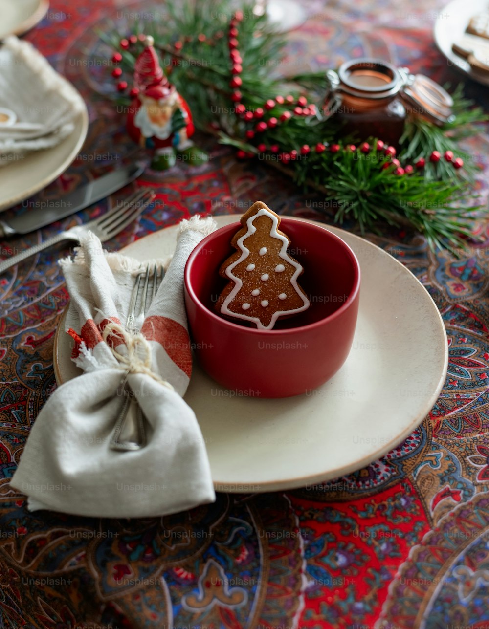 a red bowl with a gingerbread cookie in it