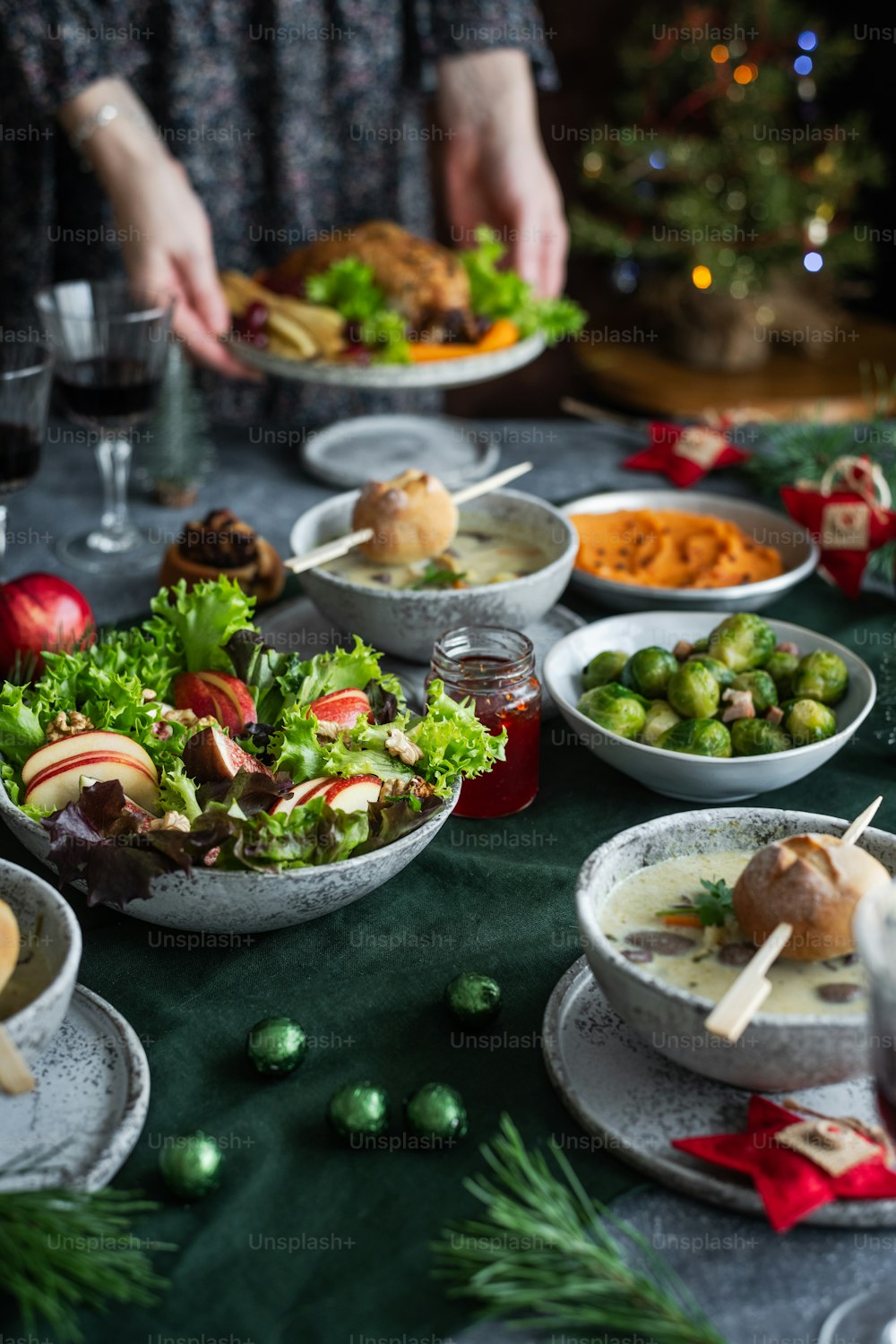 a table filled with plates of food and glasses of wine