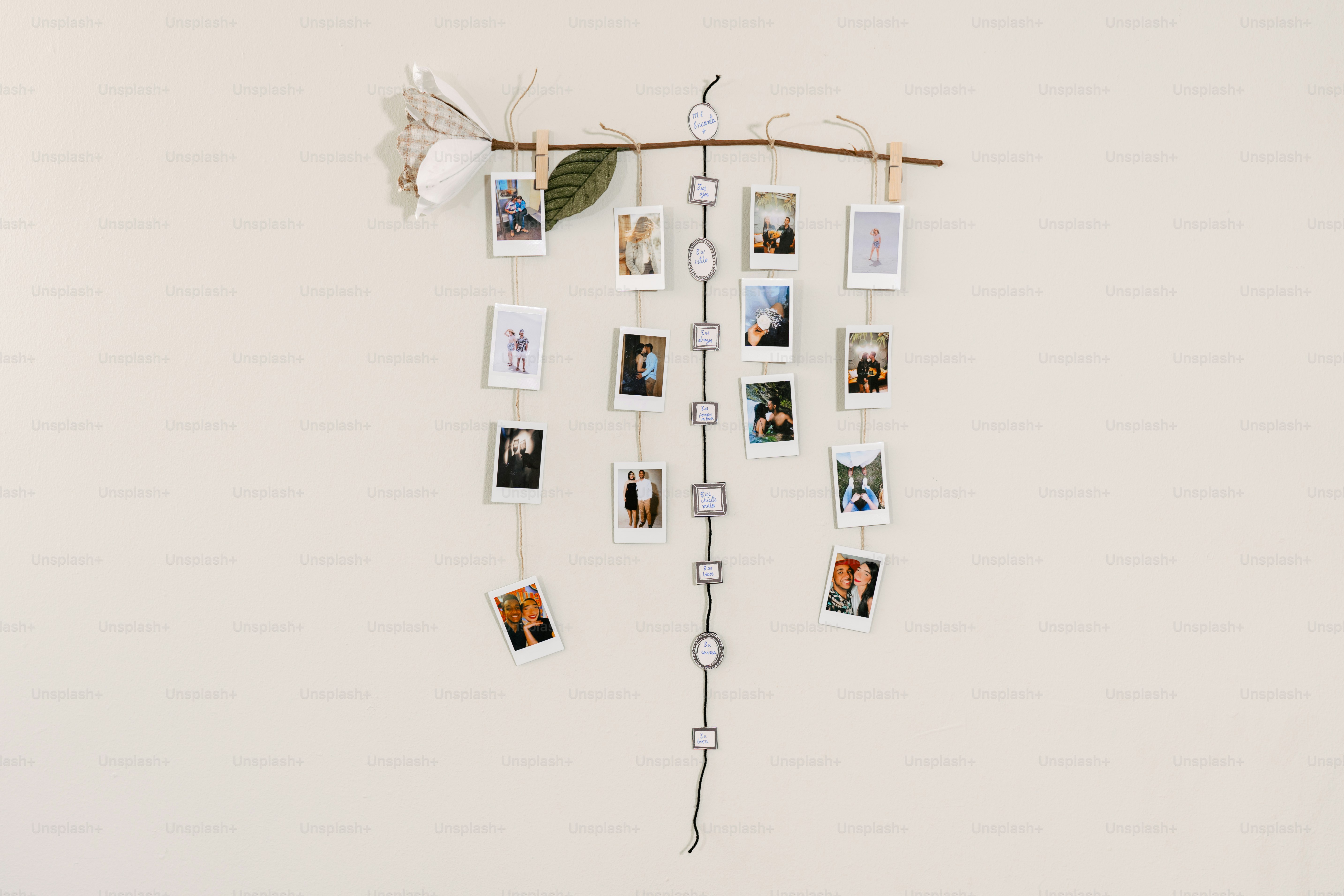 a white wall with a bunch of pictures hanging on it