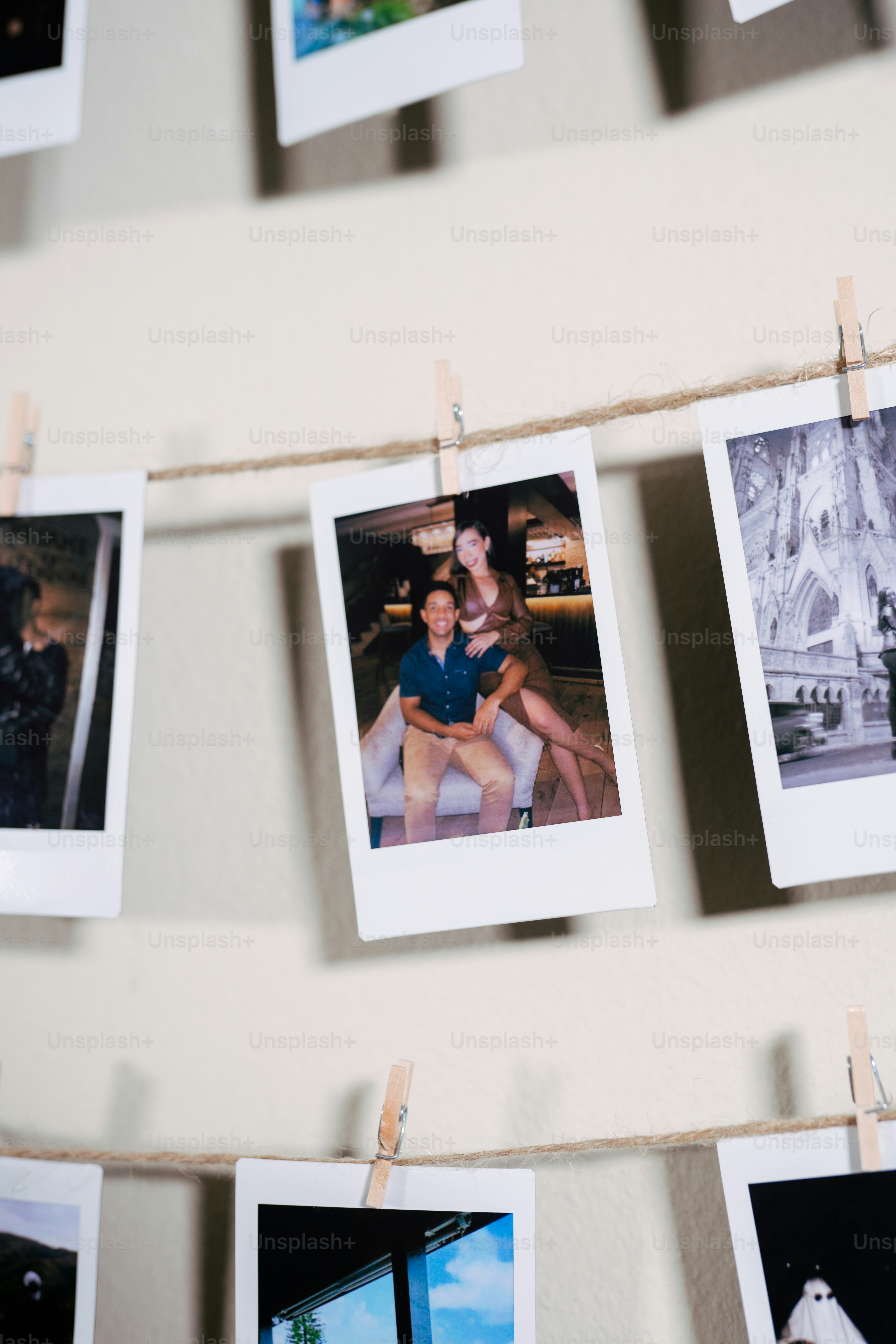 a couple of pictures hanging on a clothes line