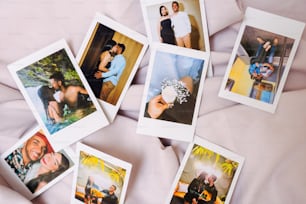 a bunch of polaroid pictures are laying on a bed