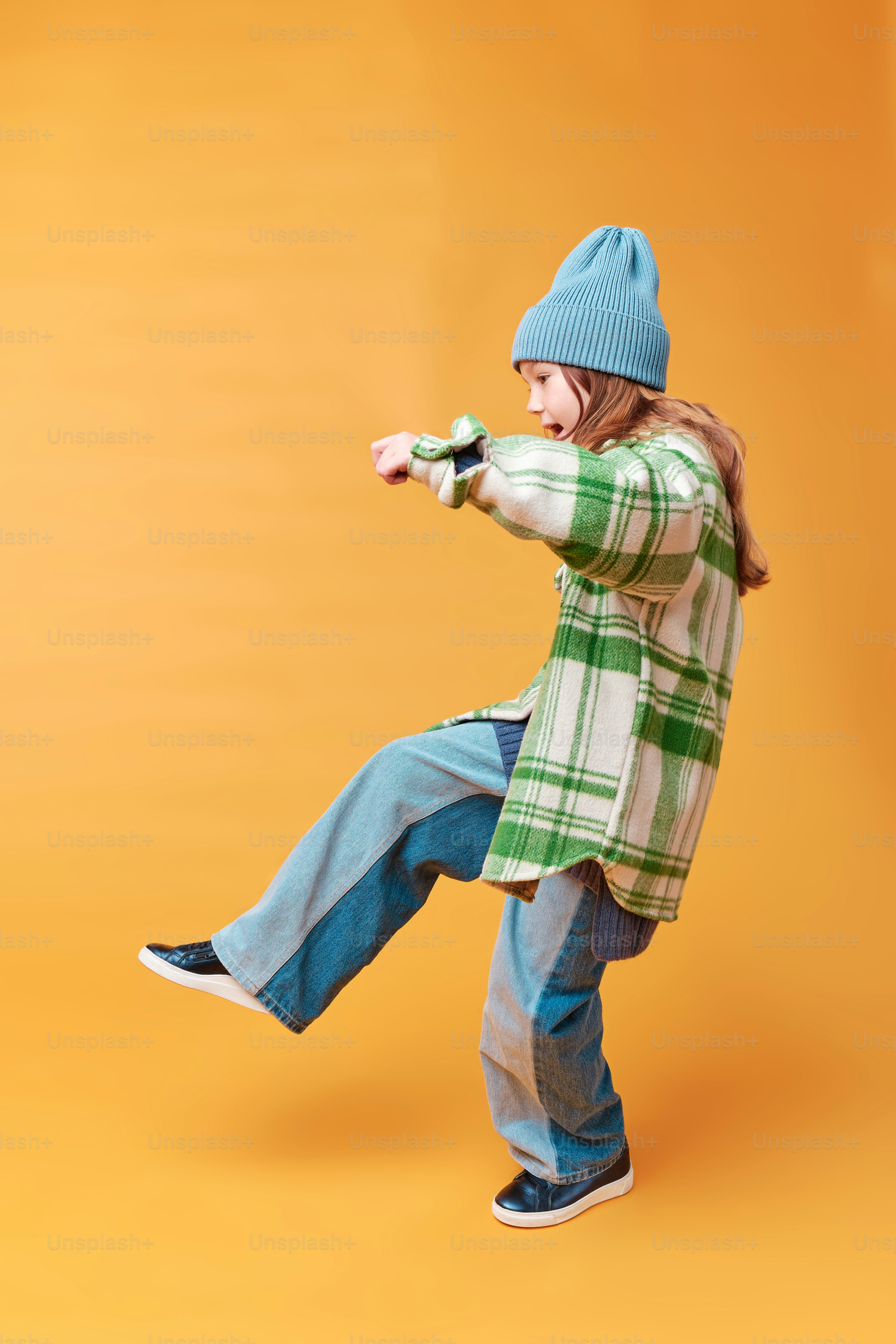 a young boy is doing a trick on a skateboard