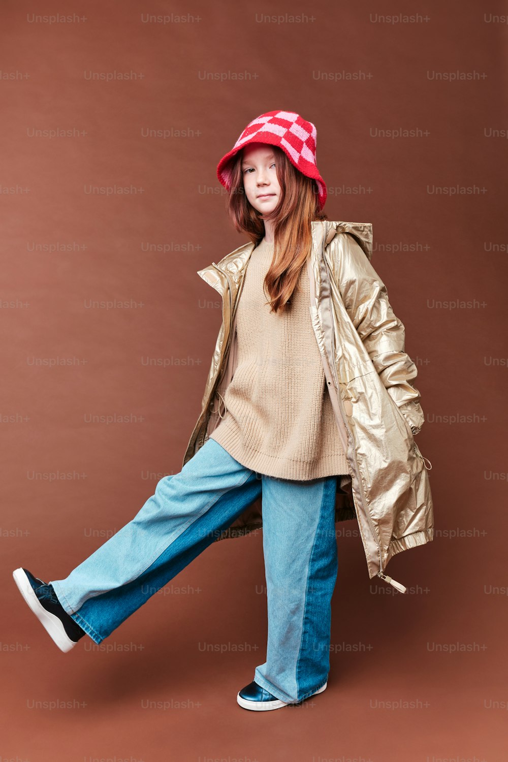 a young girl wearing a red hat and jacket