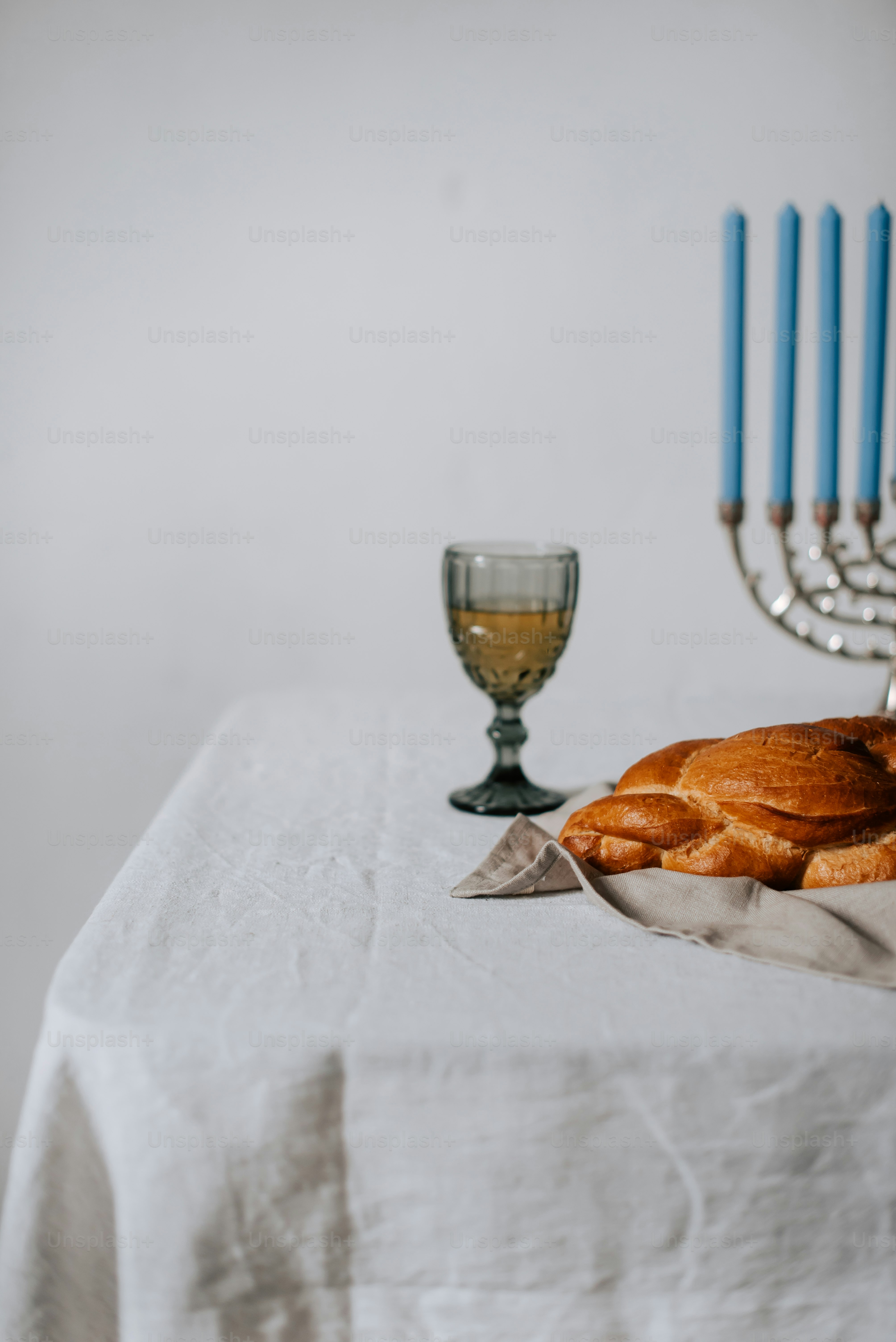 A table topped with bread and a menorah photo Hanukkah Image on Unsplash
