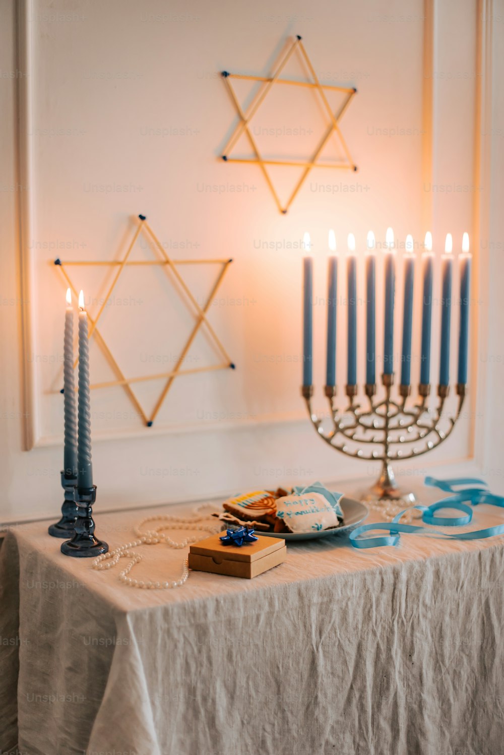 a table topped with a hanukkah menorah