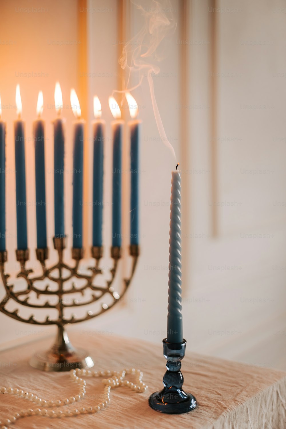 a lit menorah with a chain of candles