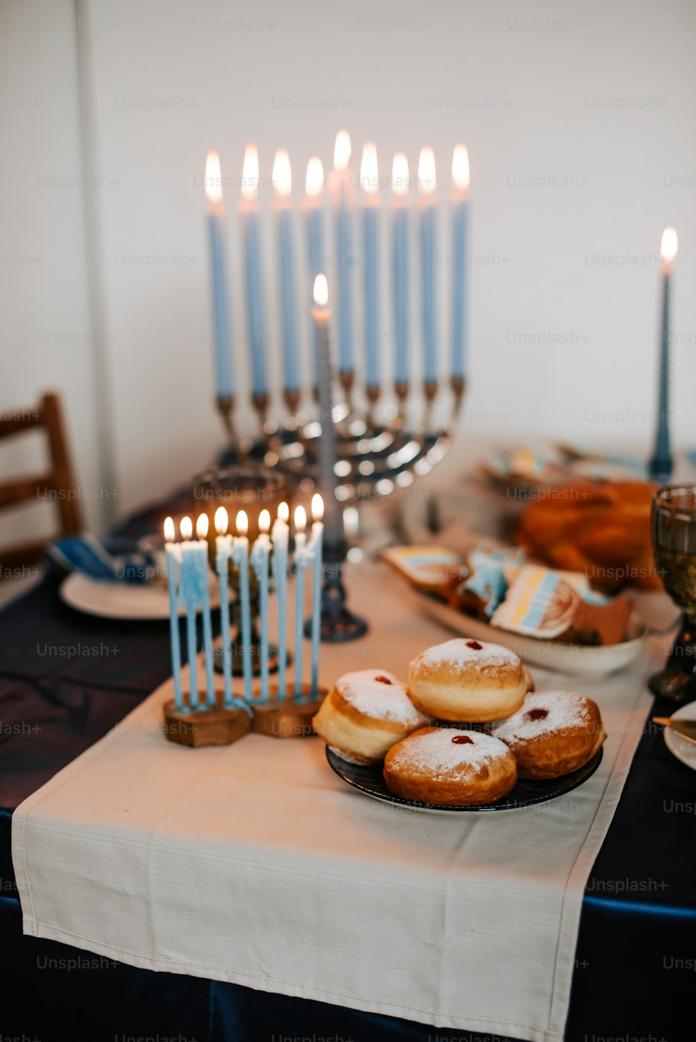 a table topped with donuts and lit candles