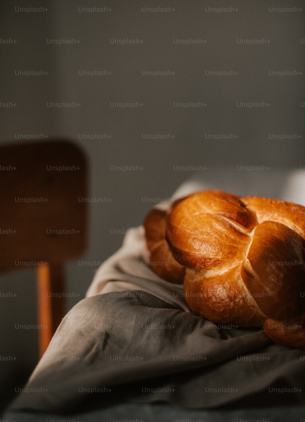 a pile of bread sitting on top of a bed