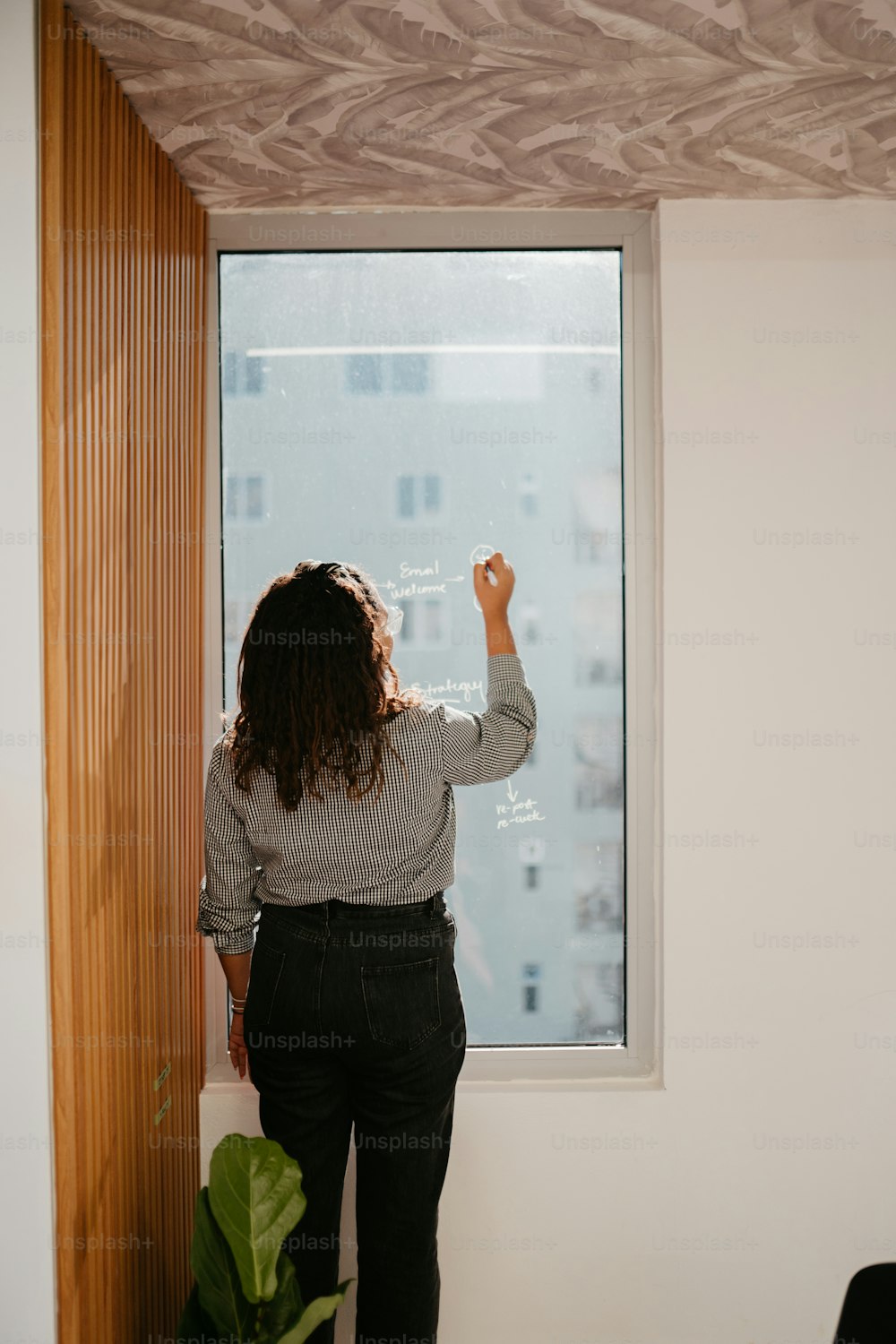 a woman standing in front of a window