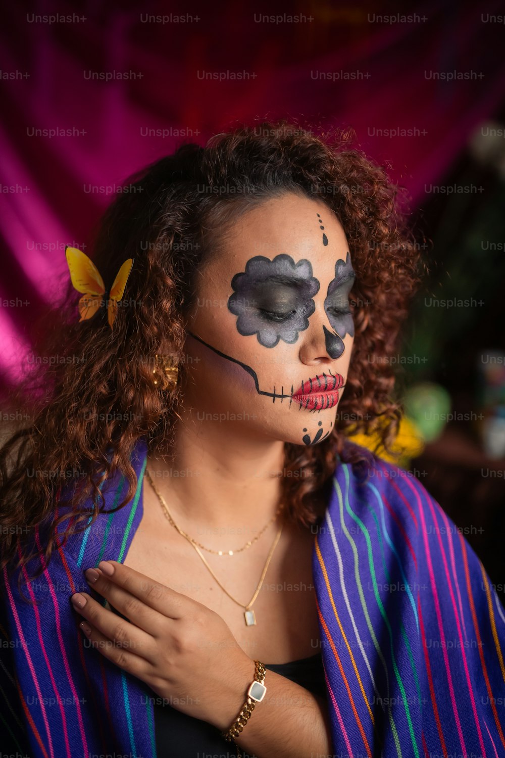 a woman with her face painted like a skeleton