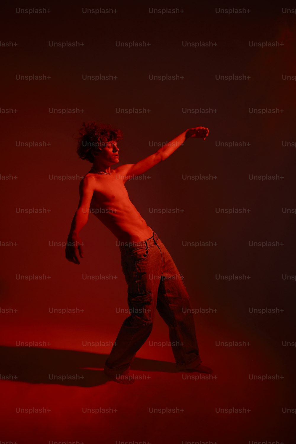 a shirtless man is standing in the dark