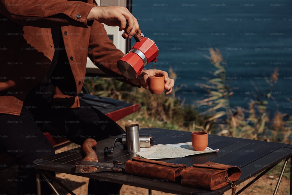 a person sitting at a table with a cup of coffee