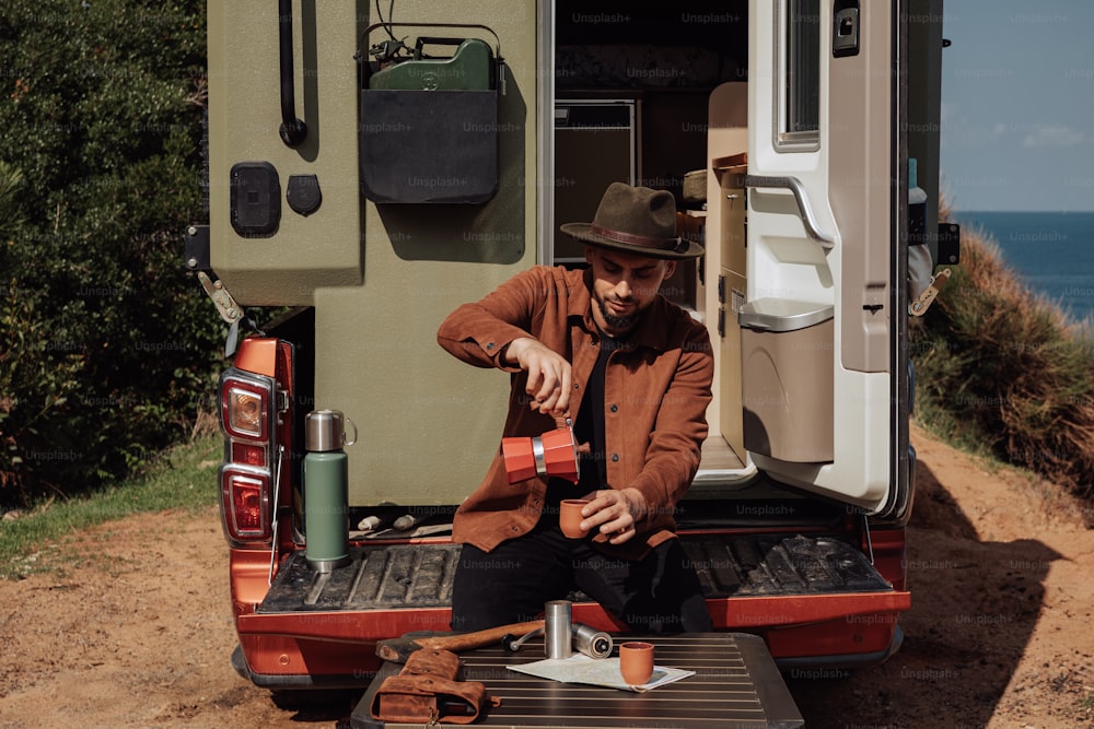 a man sitting in the back of a truck